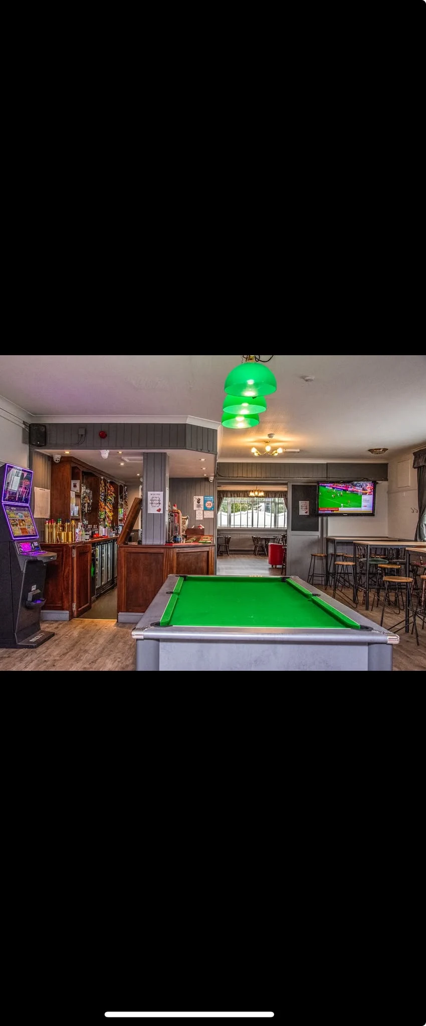 Wide view of the pool table and bar