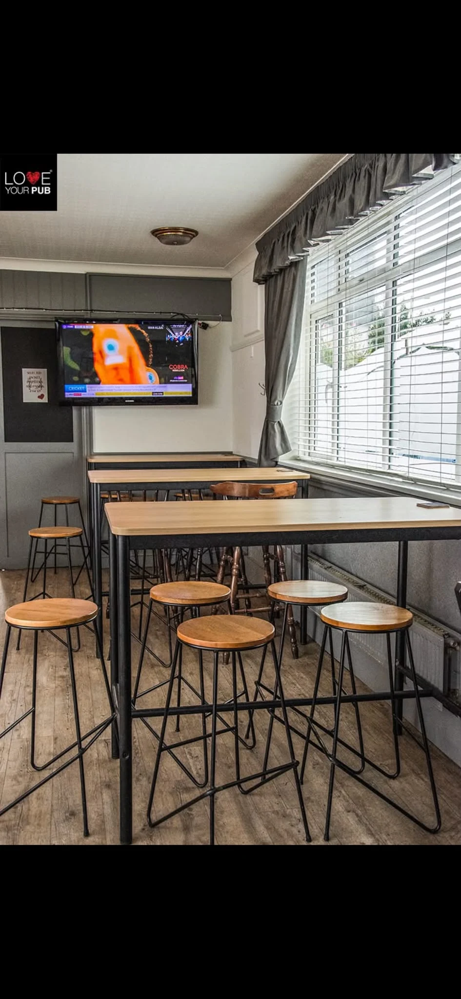 High tables and television inside The Falcon